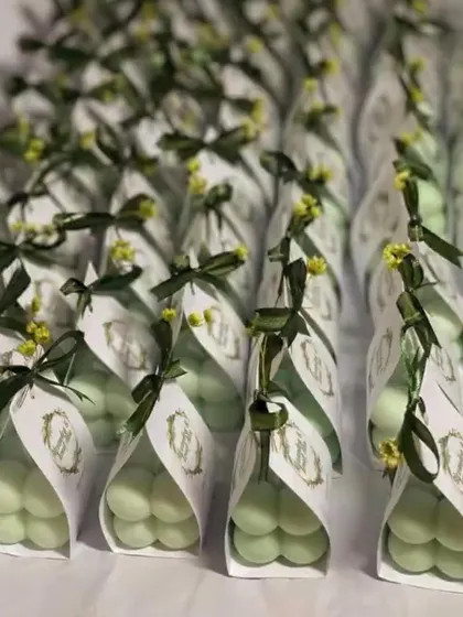 A row of our elegant green and gold baby bubble candle favors, perfect for a sophisticated wedding theme.