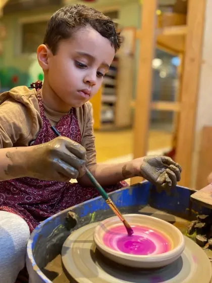 Adding the finishing touches. After shaping their creation, children get to paint their pottery, making each piece a unique expression of their personality.
