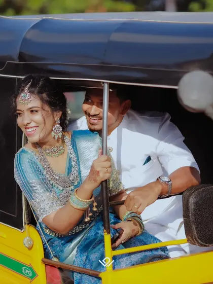 A fun-loving couple enjoys a ride in an auto-rickshaw, a candid moment full of laughter.