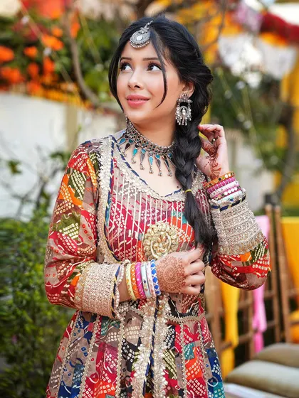 I create vibrant content for festive and wedding seasons. This look features a multi-colored 'banjara' style outfit with intricate details and oxidized jewelry, perfect for brands targeting the celebratory Indian market.