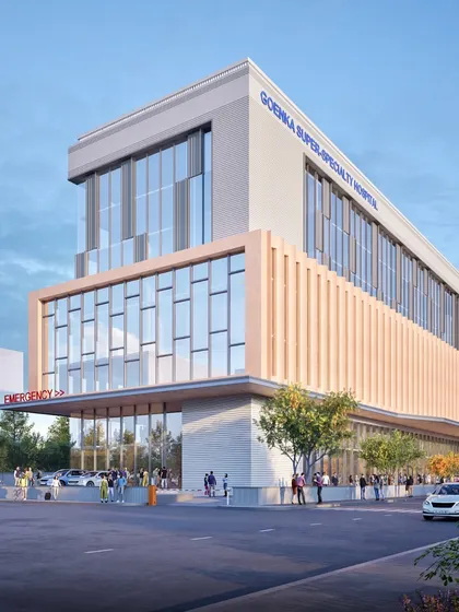 Another view of the Goenka Super Speciality Hospital, highlighting the clearly defined emergency entrance. The design aims to deliver accessible, patient-first care in a state-of-the-art facility, set to open in 2026.