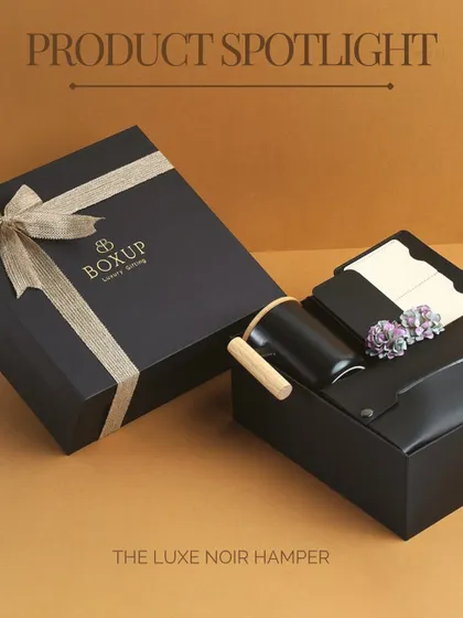 A product spotlight on the Luxe Noir Hamper. The elegant black packaging with a rustic ribbon makes this a standout choice for any corporate occasion.