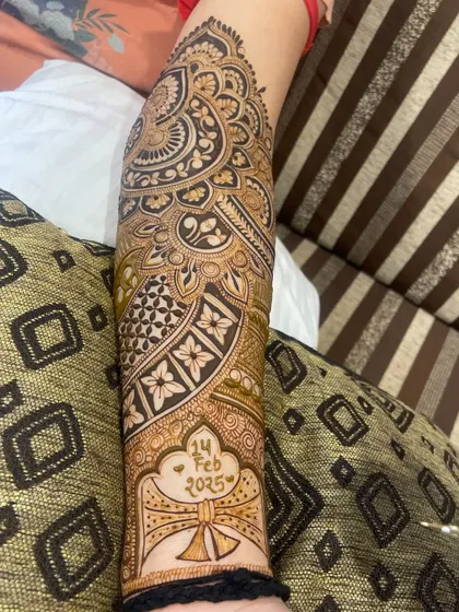 The completed arm design with the wedding date "14 FEB 2025" prominently displayed.