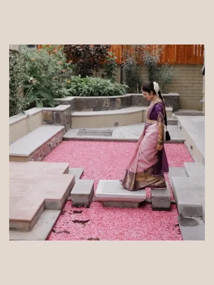 A duplicate of 271, showing the bride's graceful walk across the petal-strewn courtyard.