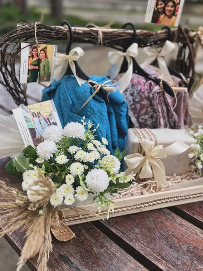 Another angle of the hanger hamper, focusing on the delicate floral arrangement and the rustic tray that grounds the entire composition.