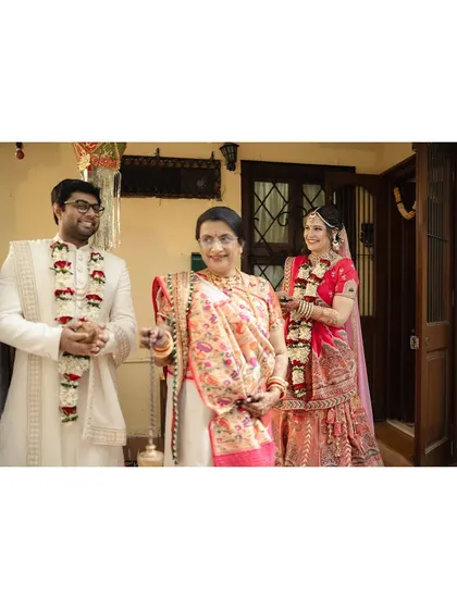 The groom and bride after the ceremony, their faces beaming with happiness. The garlands signify their new status as a married couple.