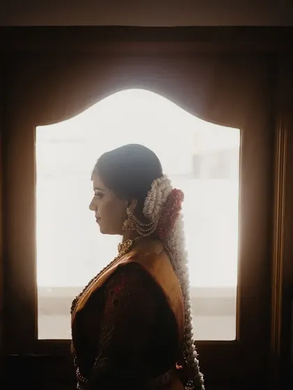 A silhouette of the bride's profile against a brightly lit window. This simple, yet powerful composition is artistic and full of quiet emotion.