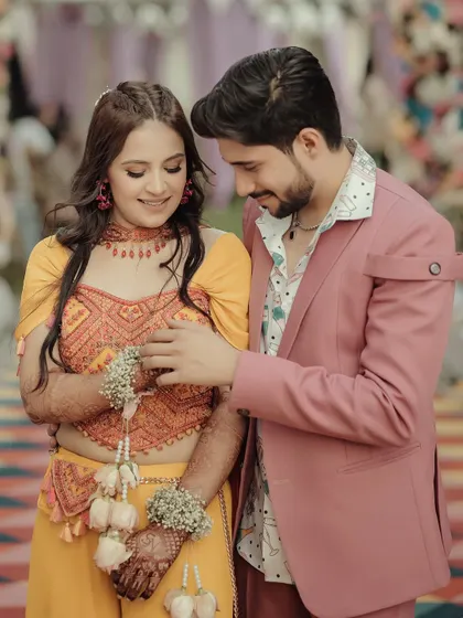 A playful and loving interaction between the couple. This candid shot captures their gentle touch and happy expressions during their pre-wedding shoot.