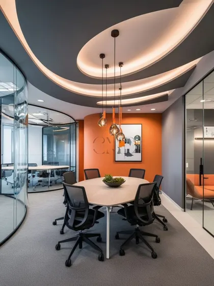 Here, an orange accent wall and a dynamic, curved ceiling with integrated lighting create a focal point in this meeting space. This demonstrates my approach to using bold design elements to energize key areas within a corporate environment.