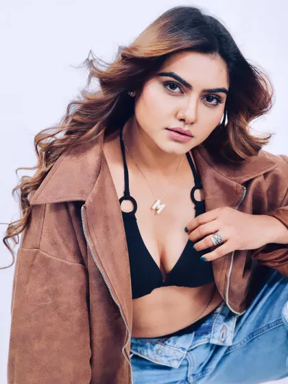A modern and casual studio look with a brown jacket and denim. This close-up shot captures a relaxed yet confident expression, perfect for a commercial portfolio.