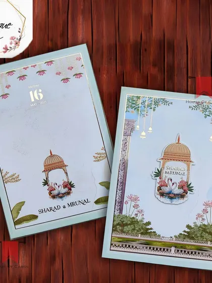 A charming pastel blue invitation with swan and birdcage motifs, creating a whimsical and romantic feel for your wedding announcement.