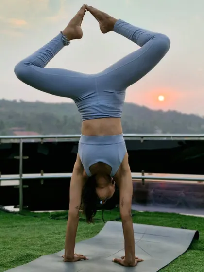A playful handstand shape against the sunset on a yacht. Being upside down is a work in progress and a masterpiece all at once.