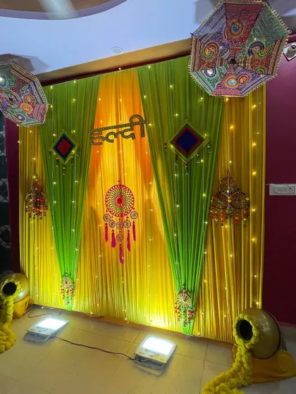 This Haldi setup shows how I use lighting to enhance the colors of the drapes. The spotlights from the floor make the yellow and green fabric glow.