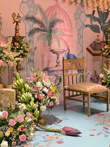 This pre-wedding celebration was a dream to design. We used a custom printed backdrop and flooring with Pichwai art, and filled the space with brass urlis, banana blossoms, and beautiful pastel florals.