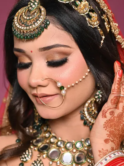 Eyes closed to showcase the beautiful golden-brown smokey eyeshadow. This look is perfect for brides who want drama and elegance.