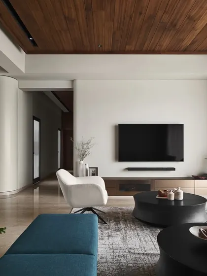 A seamless blend of comfort and elegance defines this living room. The star of the space is our custom "Forge" TV unit, finished in bronze metallic glass, which provides sophisticated storage without overpowering the room's serene aesthetic.