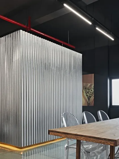 We embraced a raw, industrial aesthetic for this meeting room in a luxury Mumbai showroom. Instead of drywall, we used corrugated tin for walls and partitions, creating a space that is as bold and edgy as the ideas discussed within it.