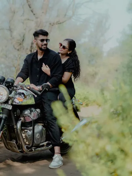 A stylish couple poses with a motorcycle during their pre-wedding shoot, perfect for those who want to add a bit of edge to their photos.