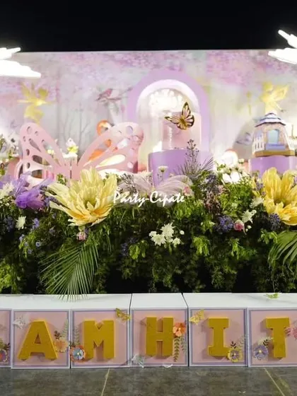 The full stage for Samhita's enchanted party, with custom name blocks, a lush floral base, and a backdrop filled with whimsical details. It was a pleasure to create this for her.