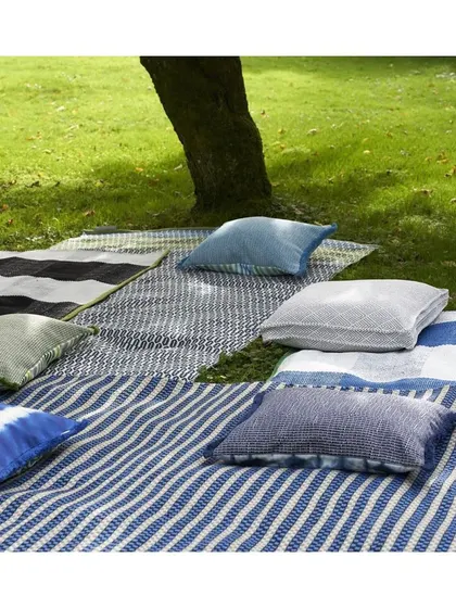 Create your own outdoor sanctuary for a picnic or lounging. This image shows a variety of outdoor fabrics in different patterns and solids, all designed to be durable and weather-resistant for stylish open-air living.