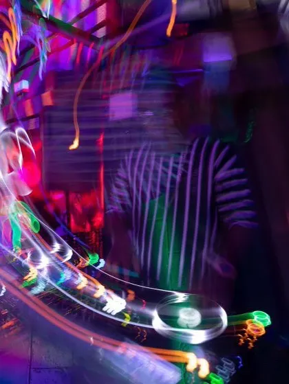 This long-exposure shot perfectly captures the motion and energy of a live DJ set. The blur of lights and movement is what a great night feels like.