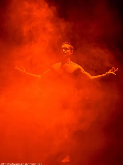A shot from the premiere of 'ATAH' where I am surrounded by vibrant orange smoke, creating a visually stunning and powerful image.