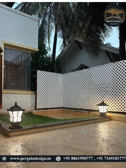Even in the rain, the surrounding garden area remains a beautiful view from the dry comfort of the glass room. The exterior is just as important, with landscape lighting and a lattice privacy screen completing the scene.