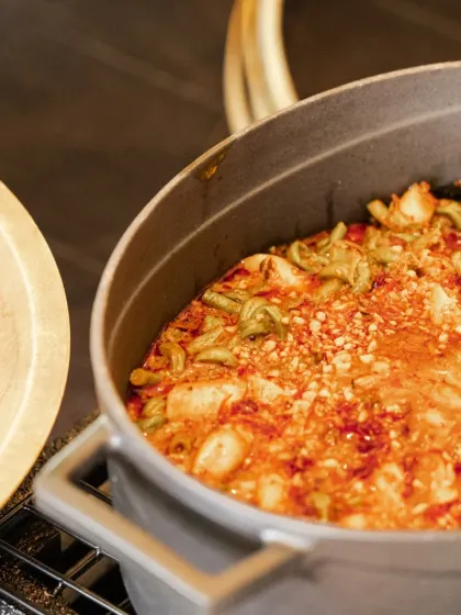 A hearty and flavorful stew, slow-cooked in a cast-iron pot. This dish is perfect for a wedding buffet, offering guests a warm and satisfying main course option.