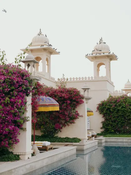 The serene pool and vibrant bougainvillea at The Oberoi Udaivilas. Capturing the beauty of the venue sets the stage for the love story that unfolds within it.