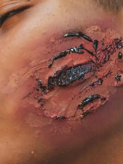 This close-up shows the detail of a facial scratch prosthetic. I carefully blend the edges of the appliance into the skin to ensure it looks like a genuine part of the face, even under intense lighting.
