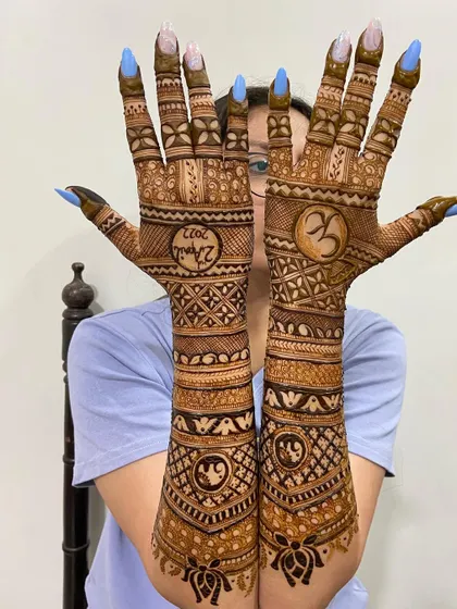 The back of the hands, with a beautiful yin-yang inspired design and the couple's wedding date.