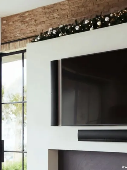 Add a touch of festivity with Definitive Technology on-wall speakers. These slim, elegant speakers flank the TV, providing powerful sound while blending seamlessly with the holiday decor.