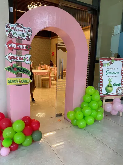 A creative entrance for a Grinch-themed party, with a custom 'Welcome to Whoville' signpost.