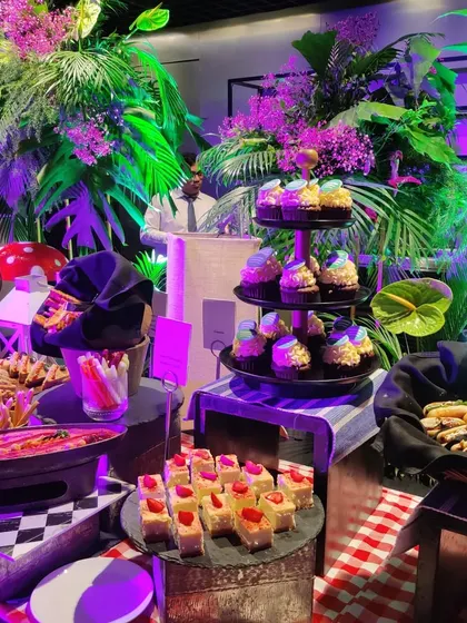 A closer look at the dessert section of our tropical grazing table for Spotify. We offered a variety of treats, including custom cupcakes, pastries, and fruit displays, all presented with creative flair.