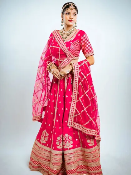 A full-length view of the Marvadi bridal lehenga, showing its beautiful silhouette and vibrant color.