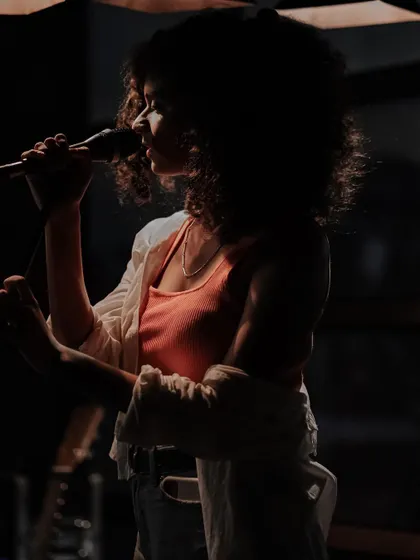 A silhouette shot during a gig, highlighting the atmosphere and my profile as a performer.