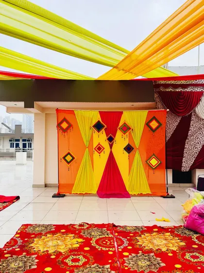 The simple and colorful backdrop stands ready for the Haldi ceremony to begin. My work is about creating the perfect setting for your memories.