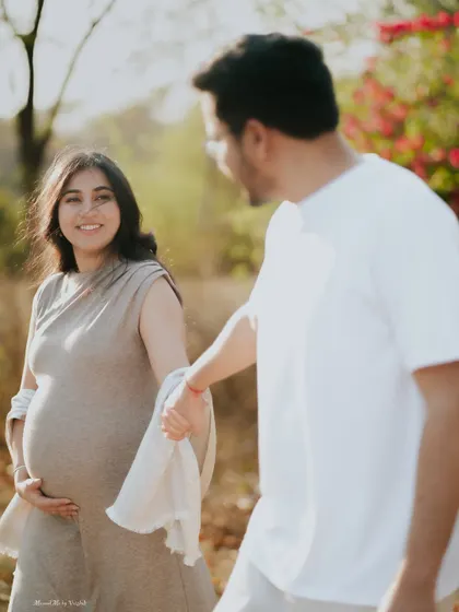 A candid, happy moment between an expecting couple. Her joyful expression as she looks at her partner tells a story of love and shared dreams.