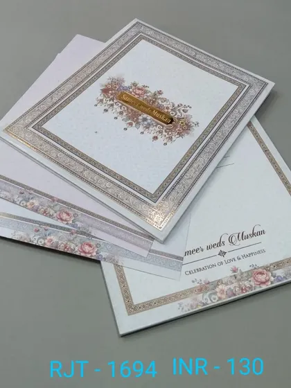 A classic invitation with a floral border and a simple, elegant layout. The design is timeless and suitable for a formal wedding.