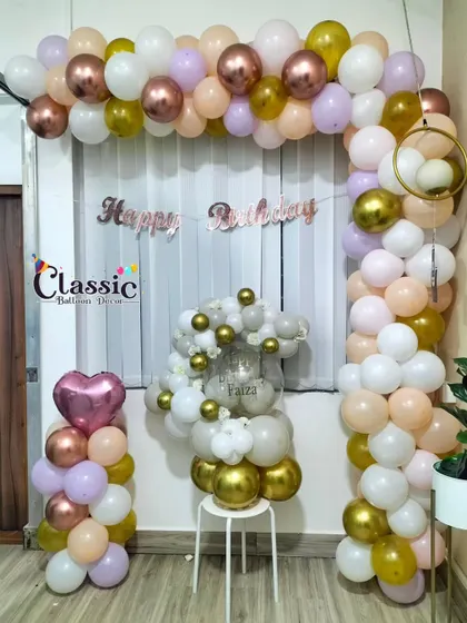 A stylish pastel balloon arch combined with a balloon bouquet, perfect for a sophisticated home party.