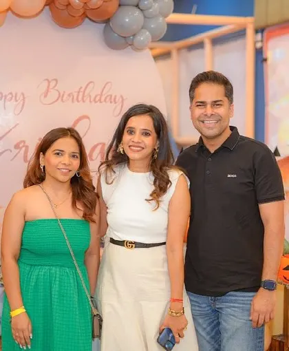 Guests posing for a photo at a pumpkin-themed birthday celebration.