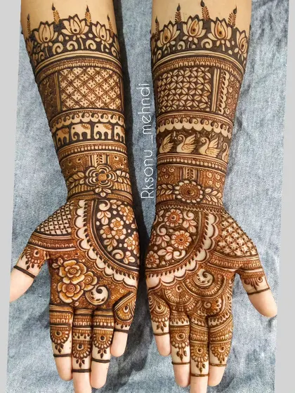A full-coverage bridal design that is rich in texture and detail. It features bands of swans and elephants on the arms, with a beautiful mix of floral and geometric patterns on the palms.