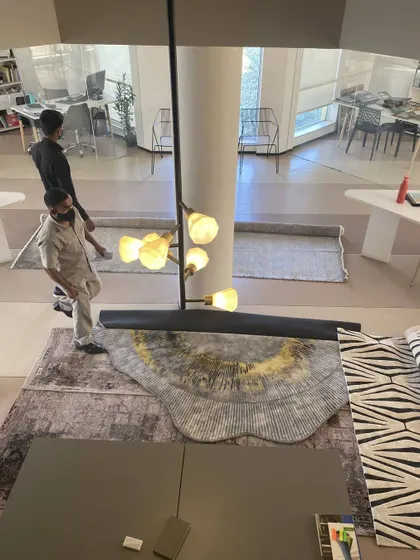 Another look at our material selection process. This high-angle shot captures the variety of carpet samples being reviewed in our studio, a testament to our commitment to quality and finding the right aesthetic for every client.