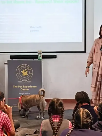 A close up of me and Miney during the presentation. The slide behind us talks about respecting an animal's space, a key takeaway from our compassion workshops.
