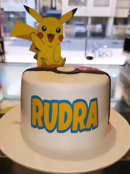 Gotta catch 'em all. This Pokémon cake features a cheerful Pikachu topper and the birthday boy's name in the classic Pokémon font.