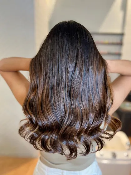 A stunning chocolate brown balayage. This is a perfect example of a French balayage, with a seamless, natural-looking blend.