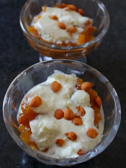 A close-up of our apricot delight, also known as 'khubani ka meetha'. This traditional Hyderabadi dessert is made with dried apricots and topped with cream and almonds.