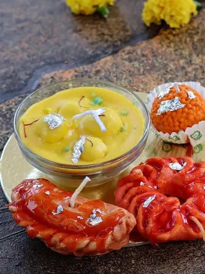 My 'Mooh Meetha' candle box, featuring a variety of my most realistic dessert candles. This set includes a rasmalai bowl, a gujiya, an imarti, and a laddoo candle.