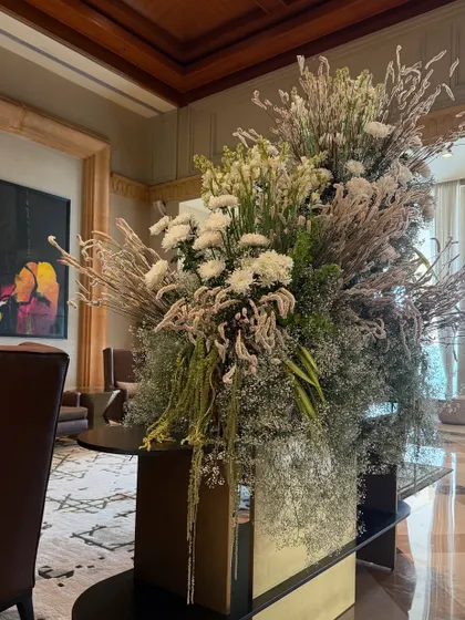 An all-white arrangement brings a sense of serene elegance to the lobby. Here, I've used a variety of white flowers and dried elements to create a piece that is rich in texture and subtlety.