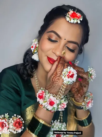 A close-up on the details. The floral jewelry, the intricate henna, and the glowing makeup all come together to create a perfect baby shower look.